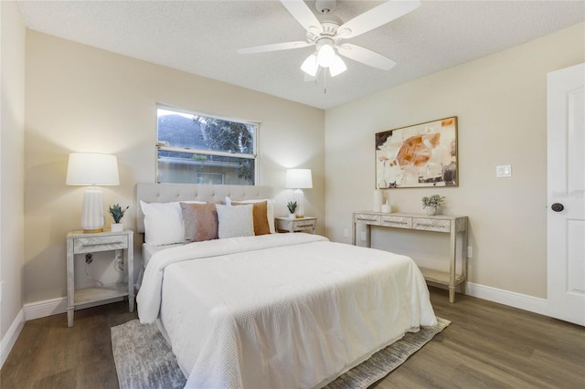 bedroom featuring a textured ceiling, ceiling fan, and dark hardwood / wood-style floors