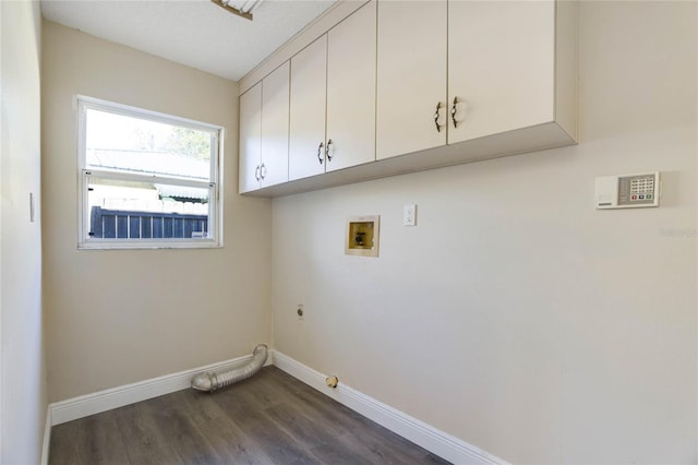 washroom with cabinets, washer hookup, dark hardwood / wood-style flooring, hookup for an electric dryer, and gas dryer hookup