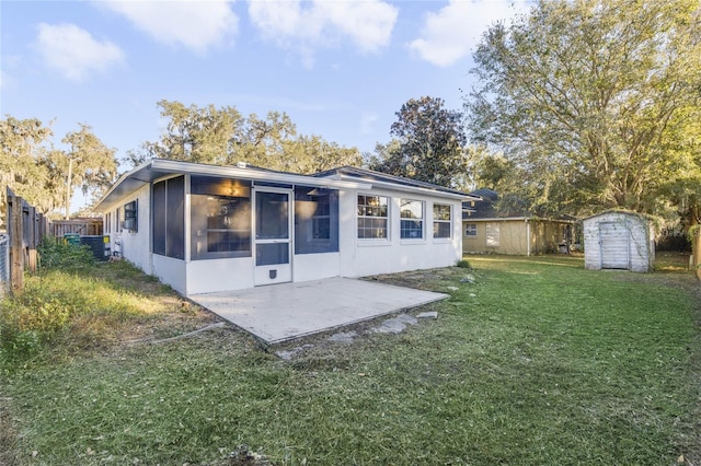 back of house featuring a patio area, a yard, and a storage unit