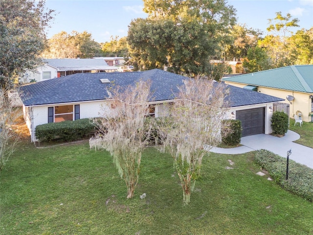 view of front of home with a garage and a front lawn