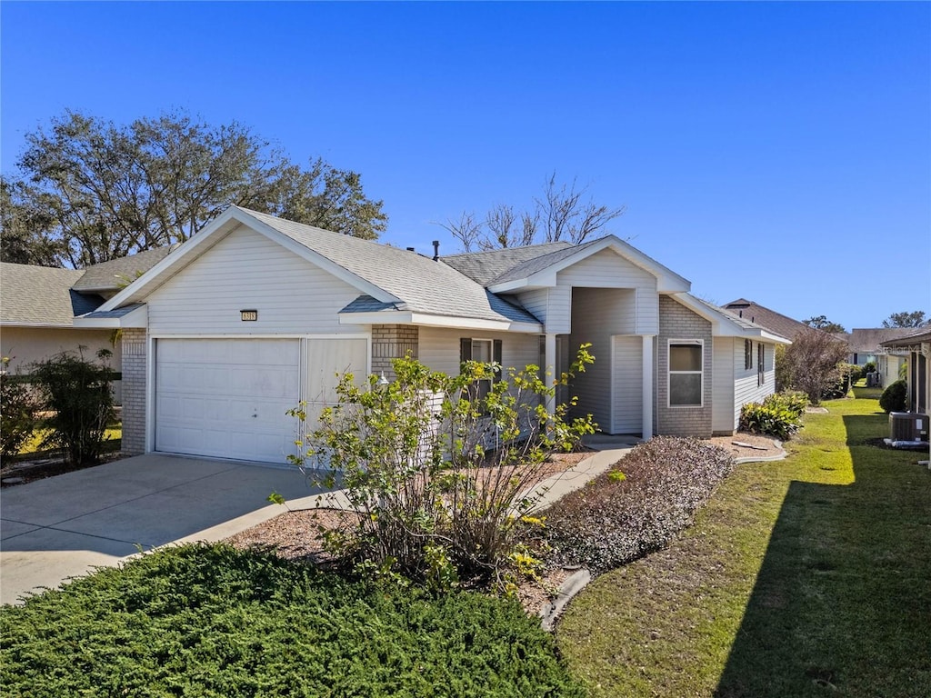 ranch-style home featuring a garage and a front lawn