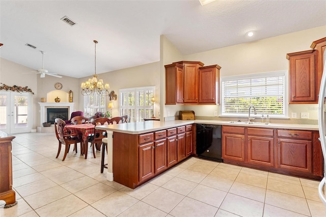 kitchen featuring kitchen peninsula, ceiling fan with notable chandelier, sink, decorative light fixtures, and dishwasher