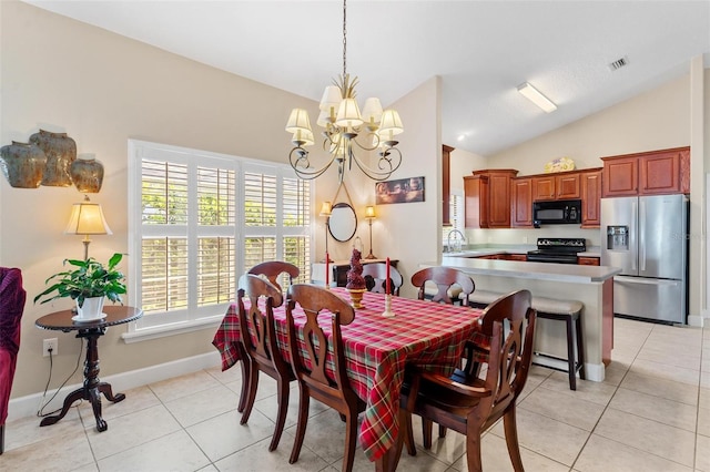 dining area featuring a notable chandelier, light tile patterned floors, sink, and vaulted ceiling