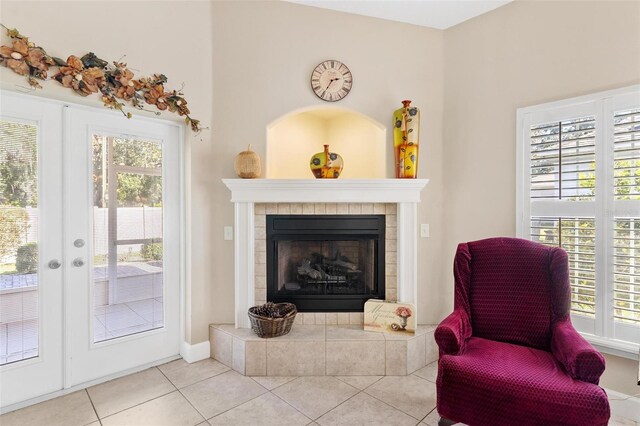 sitting room with a tile fireplace and light tile patterned floors