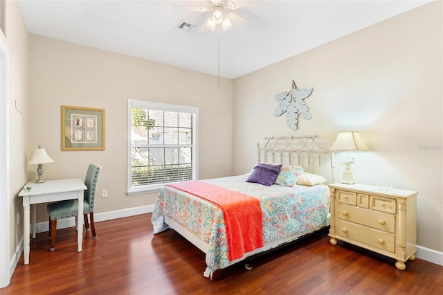 bedroom with dark hardwood / wood-style flooring and ceiling fan