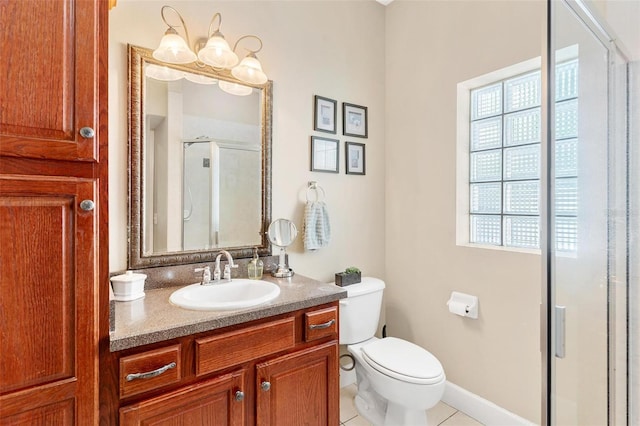 bathroom with tile patterned flooring, vanity, a shower with door, and toilet