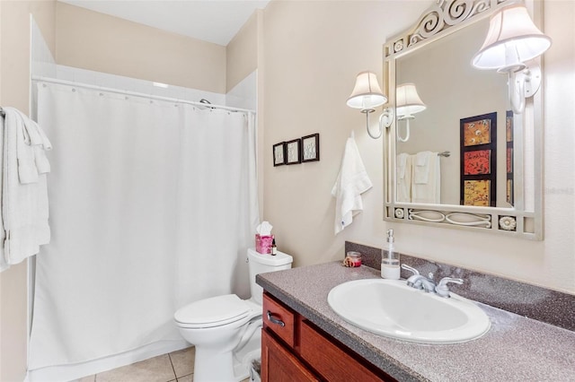 bathroom featuring tile patterned flooring, vanity, and toilet