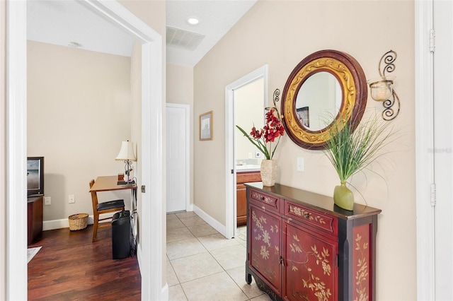 hallway with light hardwood / wood-style flooring