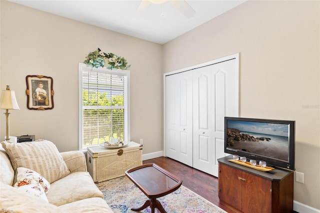 living room featuring dark hardwood / wood-style floors and ceiling fan