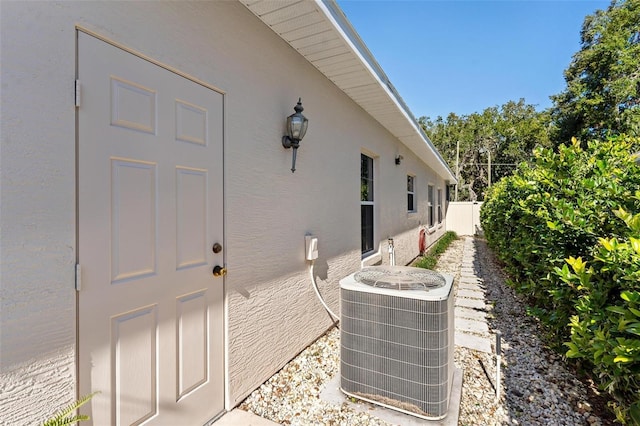 doorway to property featuring central air condition unit