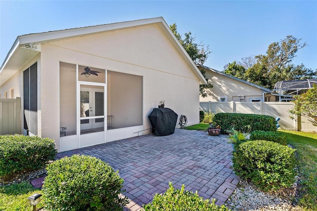 back of property featuring a patio and ceiling fan