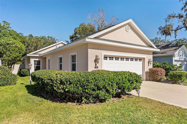 ranch-style house featuring a garage and a front lawn