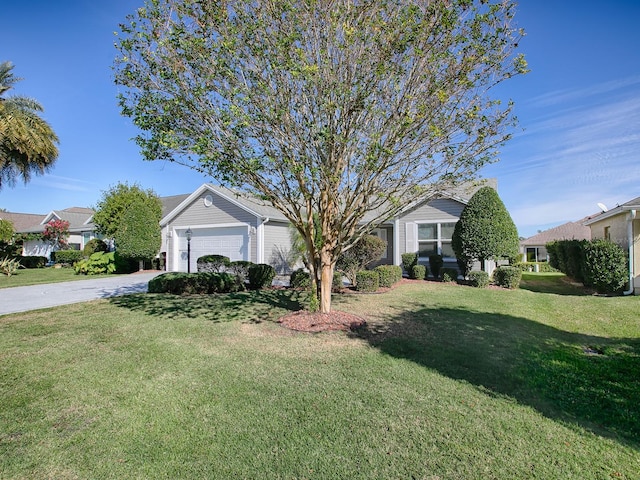 ranch-style home featuring a front yard and a garage