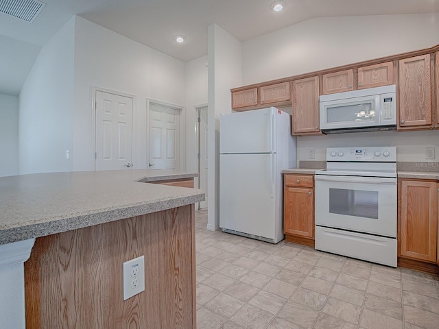 kitchen with white appliances and lofted ceiling