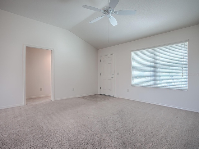 carpeted empty room featuring ceiling fan and lofted ceiling