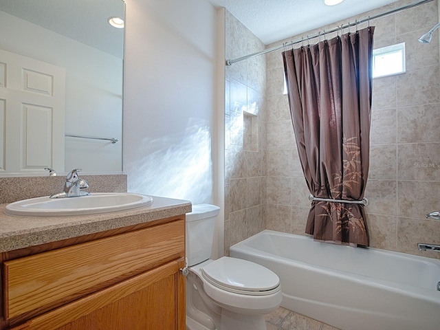 full bathroom featuring a textured ceiling, vanity, shower / bath combo, and toilet