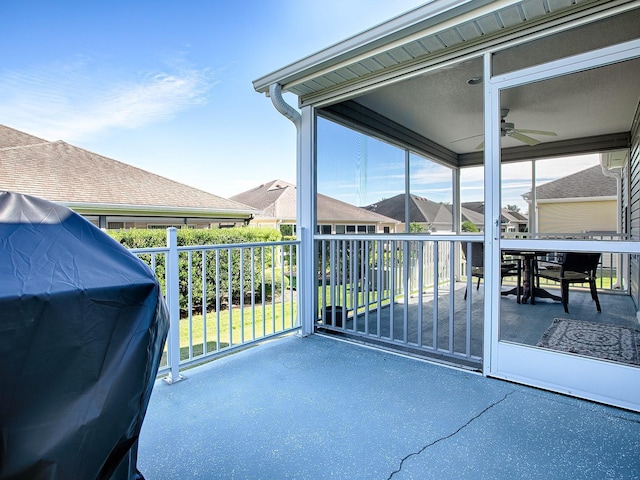 view of patio with ceiling fan, area for grilling, and a balcony