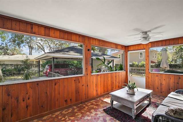 sunroom / solarium with ceiling fan and a wealth of natural light