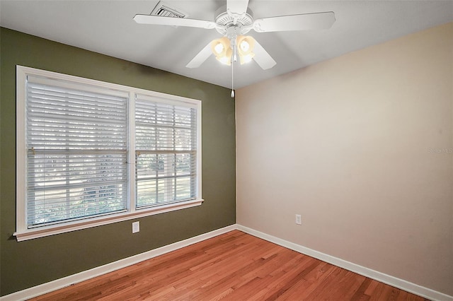 empty room featuring hardwood / wood-style floors and ceiling fan