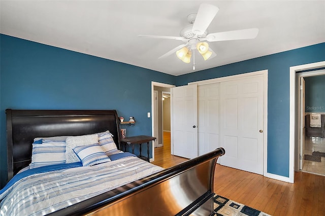 bedroom with hardwood / wood-style flooring, ceiling fan, and a closet