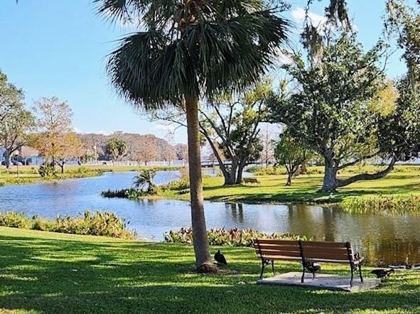 view of home's community featuring a water view and a yard