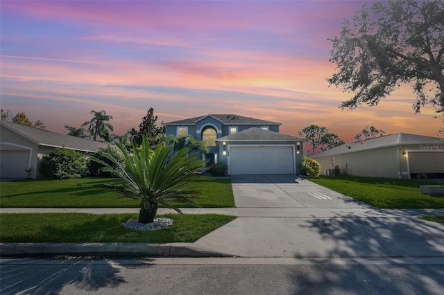 view of front of property featuring a garage and a lawn