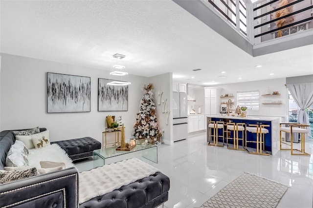 living room featuring light tile patterned floors and a textured ceiling