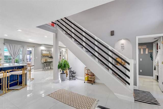 stairway featuring tile patterned flooring