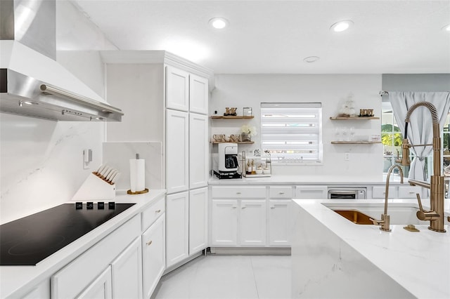 kitchen featuring ventilation hood, white cabinets, sink, light stone countertops, and black electric cooktop