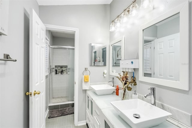 bathroom featuring tile patterned flooring, vanity, and a shower with shower door