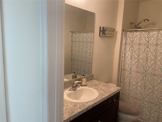 bathroom with vanity, toilet, and walk in shower