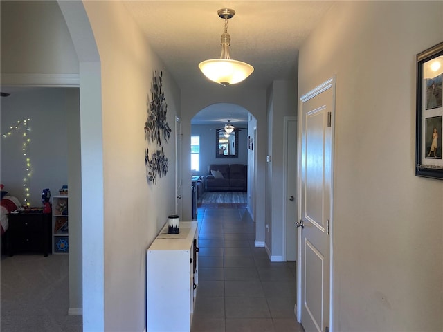 corridor with dark tile patterned flooring