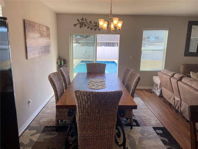 dining space featuring a notable chandelier and hardwood / wood-style flooring