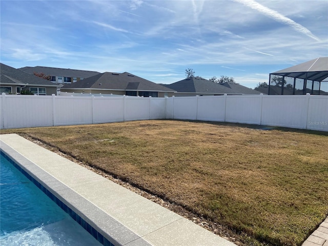 view of yard featuring glass enclosure and a fenced in pool