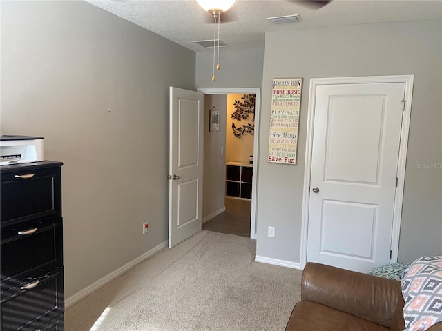 bedroom featuring carpet floors and a textured ceiling