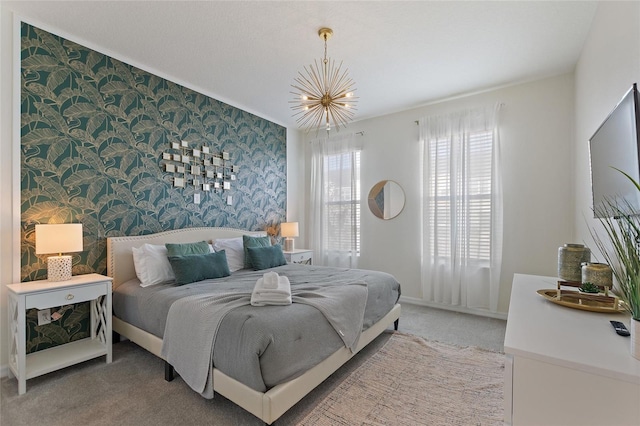 bedroom with carpet floors and a notable chandelier