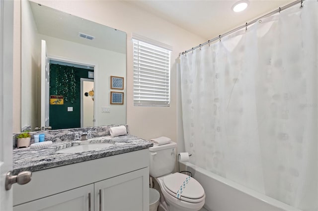 full bathroom with vanity, toilet, and shower / tub combo with curtain