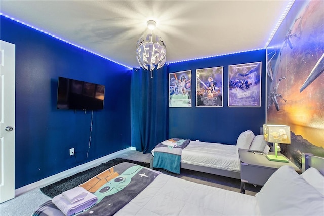 carpeted bedroom featuring an inviting chandelier