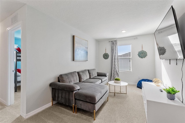 living room with light colored carpet and a textured ceiling