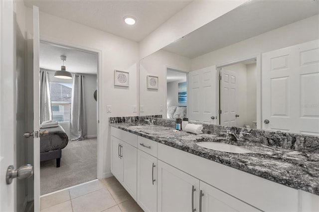 bathroom with tile patterned floors, vanity, and a textured ceiling