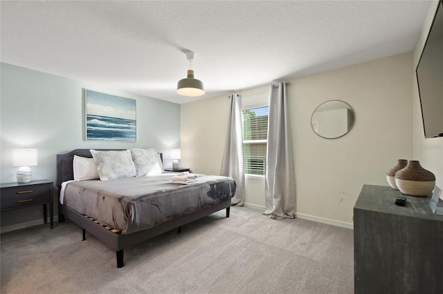 bedroom featuring a textured ceiling and light carpet