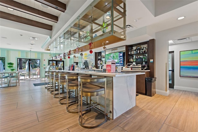 bar with beamed ceiling and plenty of natural light