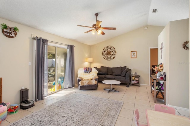 tiled living room with a textured ceiling, vaulted ceiling, and ceiling fan