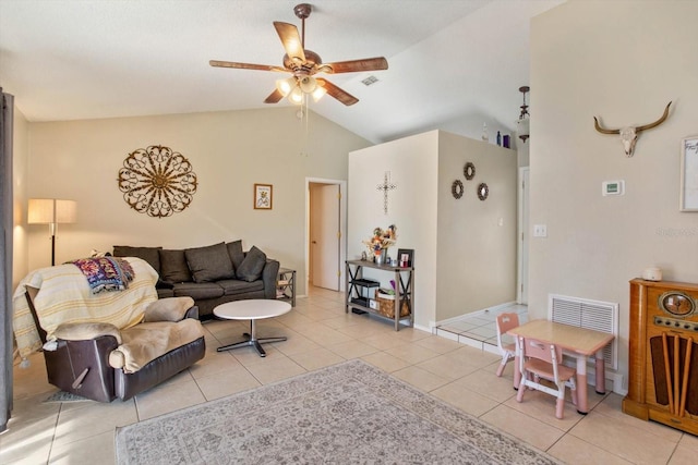 living room with ceiling fan, light tile patterned floors, and vaulted ceiling