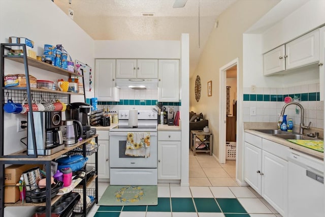 kitchen with a textured ceiling, white appliances, white cabinetry, and sink