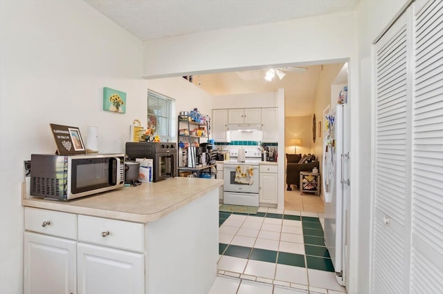 kitchen with white appliances, a textured ceiling, ceiling fan, light tile patterned floors, and white cabinetry