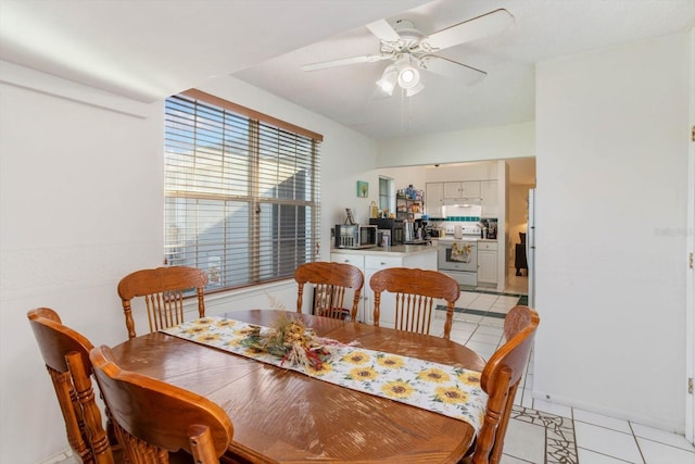 tiled dining area with ceiling fan