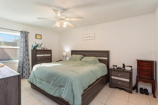 tiled bedroom featuring ceiling fan and a textured ceiling