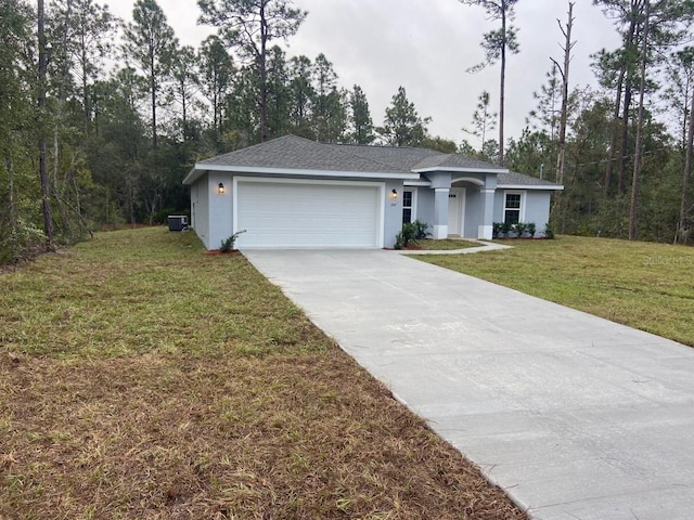 ranch-style house featuring a garage, a front lawn, and central air condition unit