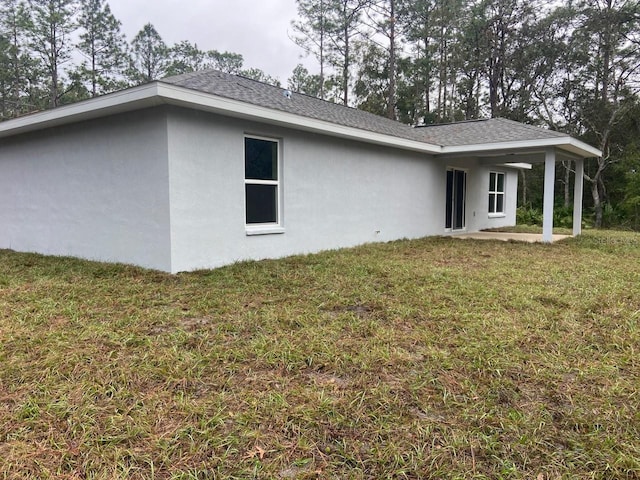 view of side of home featuring a lawn